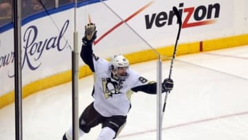 May 11, 2013; Uniondale, NY, USA; Pittsburgh Penguins center Sidney Crosby (87) celebrates a goal by Pittsburgh Penguins right wing Jarome Iginla (not pictured) against the New York Islanders during the first period of game six of the first round of the 2013 Stanley Cup Playoffs at Nassau Veterans Memorial Coliseum. Mandatory Credit: Brad Penner-USA TODAY Sports