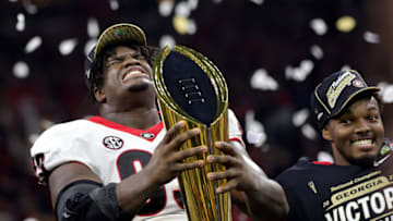 Jordan Davis celebrates with the National Championship trophy after the Georgia Bulldogs defeated the Alabama Crimson Tide 33-18 during the 2022 CFP National Championship Game. (Photo by Carmen Mandato/Getty Images)