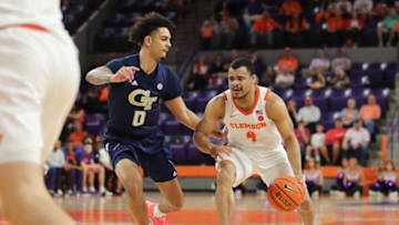 Mar 2, 2022; Clemson, South Carolina, USA; Clemson Tigers guard Nick Honor (4) moves to the basket against Georgia Tech Yellow Jackets guard Michael Devoe (0) during the first half at Littlejohn Coliseum. Mandatory Credit: Dawson Powers-USA TODAY Sports