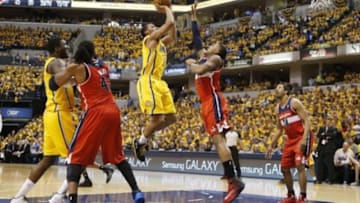 May 5, 2014; Indianapolis, IN, USA; Indiana Pacers guard Evan Turner (12) takes a shot against Washington Wizards guard Bradley Beal (3) in game one of the second round of the 2014 NBA Playoffs at Bankers Life Fieldhouse. Washington won 102-96. Mandatory Credit: Brian Spurlock-USA TODAY Sports