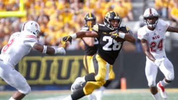 IOWA CITY, IOWA- SEPTEMBER 01: Runningback Toren Young #28 of the Iowa Hawkeyes runs up the field during the second half between safeties Mykelti Williams #8 and Trequan Smith #24 of the Northern Illinois Huskies on September 1, 2018 at Kinnick Stadium, in Iowa City, Iowa. (Photo by Matthew Holst/Getty Images)