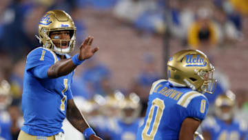PASADENA, CALIFORNIA - OCTOBER 02: Dorian Thompson-Robinson #1 of the UCLA Bruins calls a play to Kam Brown #0 during the first half against the Arizona State Sun Devils at Rose Bowl on October 02, 2021 in Pasadena, California. (Photo by Harry How/Getty Images)