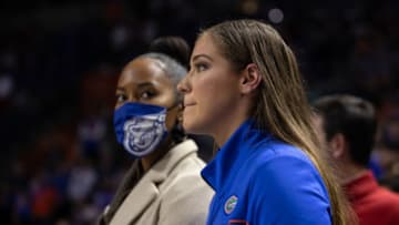 Jan 5, 2022; Gainesville, Florida, USA; Florida Gators assistant athletic director Katie Turner watches Florida Gators football head coach Billy Napier speak during halftime at Billy Donovan Court at Exactech Arena. Mandatory Credit: Matt Pendleton-USA TODAY Sports