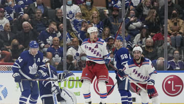 Oct 18, 2021; Toronto, Ontario, CAN; New York Rangers forward Artemi Panarin (10) celebrates his overtime winning goal as forward Mika Zibanejad (93) and Toronto Maple Leafs defenseman Morgan Rielly (44) and forward Michael Bunting (58) look on at Scotiabank Arena. Mandatory Credit: John E. Sokolowski-USA TODAY Sports