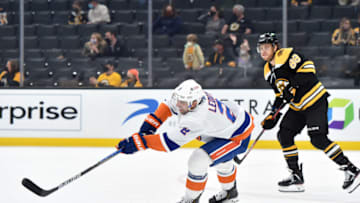 May 10, 2021; Boston, Massachusetts, USA; New York Islanders defenseman Nick Leddy (2) clears the puck out of the zone while Boston Bruins right wing David Pastrnak (88) looks on during the second period at TD Garden. Mandatory Credit: Bob DeChiara-USA TODAY Sports