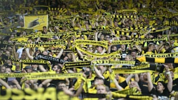 Borussia Dortmund supporters cheer for the team against Eintracht Frankfurt (Photo by INA FASSBENDER/AFP via Getty Images)