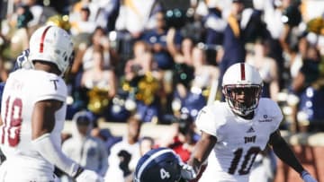 STATESBORO, GA - NOVEMBER 10: Shai Werts # 4 of the Georgia Southern Eagles falls into the end zone for a fourth quarter touchdown in between Blace Brown #18 and Will Sunderland #10 of the Troy Trojans during on November 10, 2018 in Statesboro, Georgia. (Photo by Chris Thelen/Getty Images)