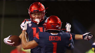 TUCSON, ARIZONA - SEPTEMBER 07: Wide receiver Tayvian Cunningham #11 of the Arizona Wildcats celebrates with Drew Dixon #1 after scoring on a 47 yard touchdown against the Northern Arizona Lumberjacks during the first half of the NCAAF game at Arizona Stadium on September 07, 2019 in Tucson, Arizona. (Photo by Christian Petersen/Getty Images)