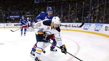 Jan 3, 2017; New York, NY, USA; Buffalo Sabres center Zemgus Girgensons (28) plays the puck against New York Rangers defenseman Brady Skjei (76) during the first period at Madison Square Garden. Mandatory Credit: Brad Penner-USA TODAY Sports