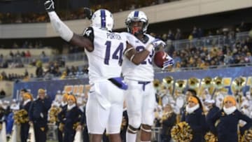 Nov 1, 2014; Morgantown, WV, USA; TCU Horned Frogs running back B.J. Catalon (23) celebrates with wide receiver David Porter (14) after scoring a touchdown during the third quarter at Milan Puskar Stadium. TCU defeated West Virginia, 31-30. Mandatory Credit: Tommy Gilligan-USA TODAY Sports