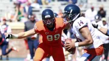Apr 6, 2013; Charlottesville, VA, USA; Virginia Cavaliers defensive tackle Brent Urban (99) chases Cavaliers quarterback Phillip Sims (14) during the spring game at Scott Stadium. Mandatory Credit: Geoff Burke-USA TODAY Sports