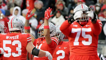 Ohio State Buckeyes wide receiver Jaxon Smith-Njigba (11) celebrates with Ohio State Buckeyes offensive lineman Luke Wypler (53) and Ohio State Buckeyes offensive lineman Thayer Munford (75) after scoring a touchdown in the second quarter of Saturday's NCAA Division I football game against the Purdue Boilermakers at Ohio Stadium in Columbus, Oh., on November 13, 2021.Osu21pur Bjp 395