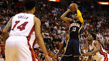 Jan 4, 2016; Miami, FL, USA; Indiana Pacers forward Paul George (13) makes a three point basket as Miami Heat forward Gerald Green (14) looks on during the second half at American Airlines Arena. The Heat won 103-100. Mandatory Credit: Steve Mitchell-USA TODAY Sports
