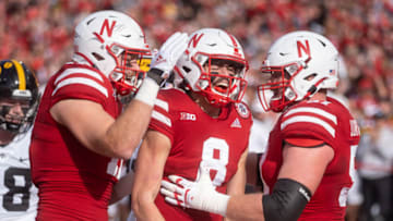 Nov 26, 2021; Lincoln, Nebraska, USA; Nebraska Cornhuskers quarterback Logan Smothers (8) celebrates after scoring against the Iowa Hawkeyes during the first quarter at Memorial Stadium. Mandatory Credit: Dylan Widger-USA TODAY Sports