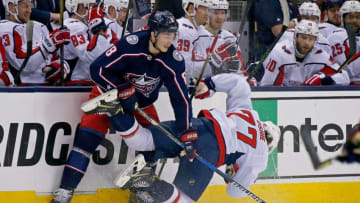 COLUMBUS, OH - APRIL 19: Zach Werenski #8 of the Columbus Blue Jackets knocks over T.J. Oshie #77 of the Washington Capitals while battling for control of the puck in Game Four of the Eastern Conference First Round during the 2018 NHL Stanley Cup Playoffs on April 19, 2018 at Nationwide Arena in Columbus, Ohio. (Photo by Kirk Irwin/Getty Images) *** Local Caption *** Zach Werenski;T.J. Oshie