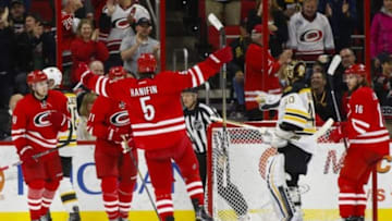 Feb 26, 2016; Raleigh, NC, USA; Carolina Hurricanes defensemen Noah Hanifin (5) celebrates with teammates after scoring a goal in the third period against the Boston Bruins at PNC Arena. The Bruins won 4-1. Mandatory Credit: James Guillory-USA TODAY Sports