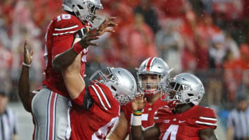 Sep 10, 2016; Columbus, OH, USA; Ohio State Buckeyes quarterback J.T. Barrett (16) celebrates with teammates after scoring a touchdown in the second half against the Tulsa Golden Hurricane at Ohio Stadium. Ohio State won 48-3. Mandatory Credit: Aaron Doster-USA TODAY Sports