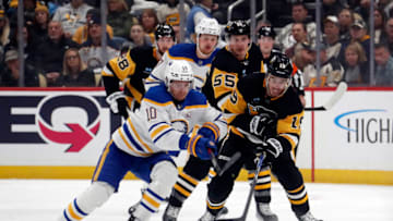 Nov 11, 2023; Pittsburgh, Pennsylvania, USA; Buffalo Sabres defenseman Henri Jokiharju (10) and Pittsburgh Penguins right wing Reilly Smith (19) chase the puck during the first period at PPG Paints Arena. Mandatory Credit: Charles LeClaire-USA TODAY Sports