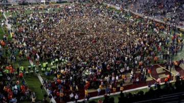 Sep 13, 2014; Boston, MA, USA; Boston College Eagles fans rush the field after the Boston College Eagles defeated the Southern California Trojans 37-31 at Alumni Stadium. Mandatory Credit: Greg M. Cooper-USA TODAY Sports