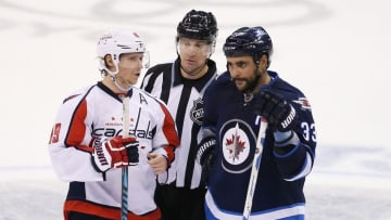 Nov 1, 2016; Winnipeg, Manitoba, CAN; Washington Capitals center Nicklas Backstrom (19) speaks with Winnipeg Jets defenseman Dustin Byfuglien (33) during the second period at MTS Centre. Mandatory Credit: Bruce Fedyck-USA TODAY Sports