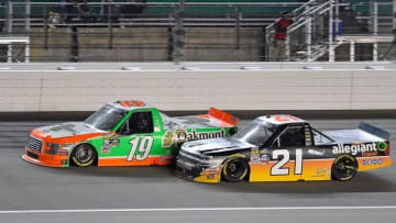 May 6, 2016; Kansas City, KS, USA; NASCAR Camping World Truck Series drivers Johnny Sauter (21) and Daniel Hemric (19) race during the Toyota Tundra 250 at Kansas Speedway. Mandatory Credit: Jasen Vinlove-USA TODAY Sports