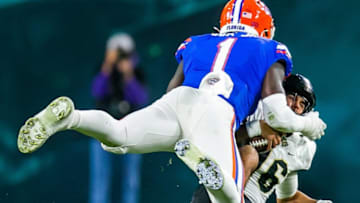 Florida Gators linebacker Brenton Cox Jr. (1) sacks UCF Knights quarterback Mikey Keene (16). The Gators lead 10-9 over the Central Florida Knights at the half in the Gasparilla Bowl Thursday, December 23, 2021, at Raymond James Stadium in Tampa, FL. [Doug Engle/Ocala Star-Banner]2021Oca 122324 Ufvsucfgasbowl
