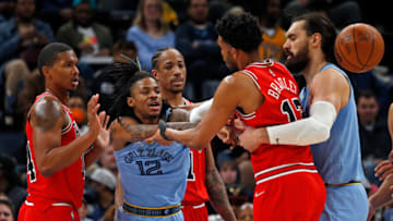 Jan 17, 2022; Memphis, Tennessee, USA; Memphis Grizzles guard Ja Morant (12) and Chicago Bulls center Tony Bradley (13) shove each other as Grizzles center Steven Adams (4) tries to break it up during the second half at FedExForum. Mandatory Credit: Petre Thomas-USA TODAY Sports