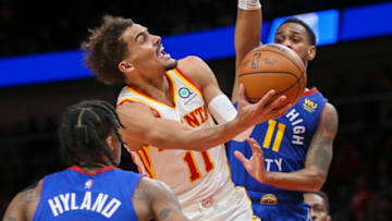 Dec 17, 2021; Atlanta, Georgia, USA; Atlanta Hawks guard Trae Young (11) shoots past Denver Nuggets guard Monte Morris (11) in the second half at State Farm Arena. Mandatory Credit: Brett Davis-USA TODAY Sports