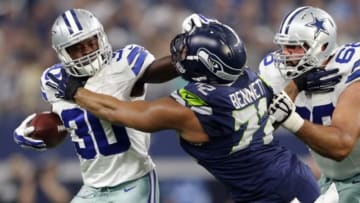 Nov 1, 2015; Arlington, TX, USA; Dallas Cowboys running back Christine Michael (30) stiff arms Seattle Seahawks defensive end Michael Bennett (72) during the first half at AT&T Stadium. Mandatory Credit: Kevin Jairaj-USA TODAY Sports