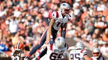 CLEVELAND, OHIO - OCTOBER 16: Cole Strange #69 of the New England Patriots celebrates with Tyquan Thornton #11 of the New England Patriots after Thornton's touchdown during the third quarter against the Cleveland Browns at FirstEnergy Stadium on October 16, 2022 in Cleveland, Ohio. (Photo by Nick Cammett/Getty Images)
