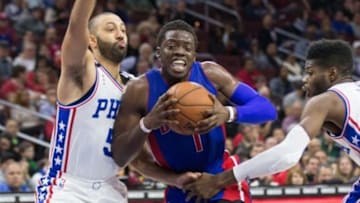 Dec 11, 2015; Philadelphia, PA, USA; Detroit Pistons guard Reggie Jackson (1) drives between Philadelphia 76ers guard Kendall Marshall (5) and forward Nerlens Noel (4) during the second half at Wells Fargo Center. The Pistons won107-95. Mandatory Credit: Bill Streicher-USA TODAY Sports