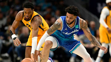 CHARLOTTE, NORTH CAROLINA - MARCH 25: Trent Forrest #3 of the Utah Jazz and Miles Bridges #0 of the Charlotte Hornets chase a loose ball during the first quarter at Spectrum Center on March 25, 2022 in Charlotte, North Carolina. NOTE TO USER: User expressly acknowledges and agrees that, by downloading and or using this photograph, User is consenting to the terms and conditions of the Getty Images License Agreement. (Photo by Eakin Howard/Getty Images)