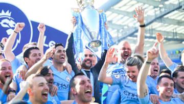 BRIGHTON, ENGLAND - MAY 12: Manchester City manager Pep Guardiola holds the Premier League trophy with backroom staff during the Premier League match between Brighton & Hove Albion and Manchester City at American Express Community Stadium on May 12, 2019 in Brighton, United Kingdom. (Photo by Michael Regan/Getty Images)