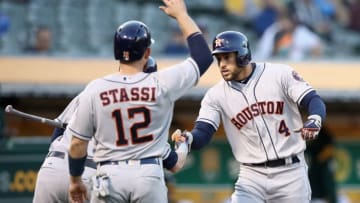 OAKLAND, CA - MAY 07: George Springer #4 of the Houston Astros is congratulated by Josh Reddick #22 and Max Stassi #12 after he hit a three-run home run in the second inning against the Oakland Athletics at Oakland Alameda Coliseum on May 7, 2018 in Oakland, California. (Photo by Ezra Shaw/Getty Images)