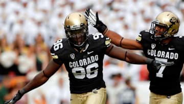 DENVER, CO - SEPTEMBER 01: Defensive lineman Chidera Uzo-Diribe #96 of the Colorado Buffaloes celebrates his sack of quarterback Garrett Grayson #18 of the Colorado State Rams with free safety Ray Polk #7 of the Colorado Buffaloes in the Rocky Mountain Showdown at Sports Authority Field at Mile High on September 1, 2012 in Denver, Colorado. (Photo by Doug Pensinger/Getty Images)