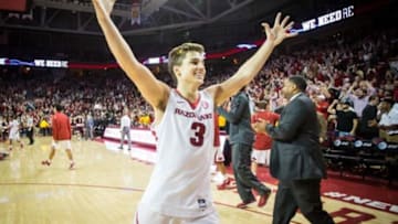 Jan 27, 2016; Fayetteville, AR, USA; Arkansas Razorbacks guard Dusty Hannahs (3) raises his arms in celebration after the Razorbacks game with the Texas A&M Aggies at Bud Walton Arena. The Razorbacks won 74-71. Mandatory Credit: Gunnar Rathbun-USA TODAY Sports
