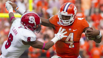 Oct 15, 2016; Clemson, SC, USA; Clemson Tigers quarterback Deshaun Watson (4) carries the ball while being defended by DNorth Carolina State Wolfpack defensive back Niles Clark (6) during the second half at Clemson Memorial Stadium. Tigers won 24-17. Mandatory Credit: Joshua S. Kelly-USA TODAY Sports