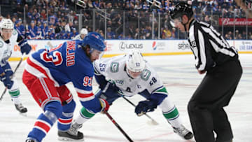 NEW YORK, NY - OCTOBER 20: Mika Zibanejad #93 of the New York Rangers wins a face-off against Bo Horvat #53 of the Vancouver Canucks at Madison Square Garden on October 20, 2019 in New York City. (Photo by Jared Silber/NHLI via Getty Images)