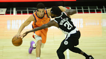Phoenix Suns guard Devin Booker (1) moves the ball against Los Angeles Clippers guard Patrick Beverley (21). Mandatory Credit: Gary A. Vasquez-USA TODAY Sports