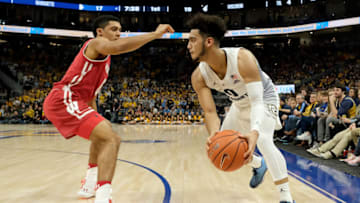 MILWAUKEE, WISCONSIN - DECEMBER 08: Markus Howard #0 of the Marquette Golden Eagles dribbles the ball while being guarded by D'Mitrik Trice #0 of the Wisconsin Badgers in the first half at the Fiserv Forum on December 08, 2018 in Milwaukee, Wisconsin. (Photo by Dylan Buell/Getty Images)