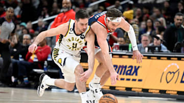 WASHINGTON, DC - FEBRUARY 11: T.J. McConnell #9 of the Indiana Pacers battles for the ball in the first quarter against Corey Kispert #24 of the Washington Wizards at Capital One Arena on February 11, 2023 in Washington, DC. NOTE TO USER: User expressly acknowledges and agrees that, by downloading and or using this photograph, User is consenting to the terms and conditions of the Getty Images License Agreement. (Photo by Greg Fiume/Getty Images)