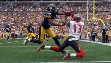 Sep 28, 2014; Pittsburgh, PA, USA; Tampa Bay Buccaneers wide receiver Mike Evans (13) catches a touchdown pass around Pittsburgh Steelers cornerback Cortez Allen (28) during the first quarter at Heinz Field. Mandatory Credit: Jason Bridge-USA TODAY Sports