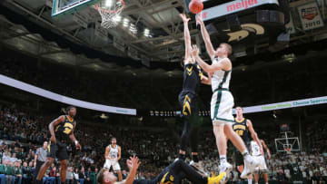 EAST LANSING, MI - DECEMBER 03: Thomas Kithier #15 of the Michigan State Spartans shoots the ball over Ryan Kriener #15 of the Iowa Hawkeyes in the first half at Breslin Center on December 3, 2018 in East Lansing, Michigan. (Photo by Rey Del Rio/Getty Images)