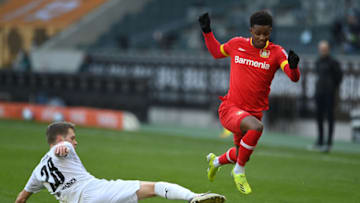 MOENCHENGLADBACH, GERMANY - MARCH 06: Demarai Gray of Bayer 04 Leverkusen is challenged by Matthias Ginter of Borussia Moenchengladbach during the Bundesliga match between Borussia Moenchengladbach and Bayer 04 Leverkusen at Borussia-Park on March 06, 2021 in Moenchengladbach, Germany. Sporting stadiums around Germany remain under strict restrictions due to the Coronavirus Pandemic as Government social distancing laws prohibit fans inside venues resulting in games being played behind closed doors. (Photo by Sascha Steinbach - Pool/Getty Images)