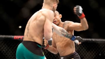LAS VEGAS, NV - DECEMBER 12: Conor McGregor (L) knocks out Jose Aldo in the first round of their featherweight title fight during UFC 194 on December 12, 2015 in Las Vegas, Nevada. (Photo by Steve Marcus/Getty Images)