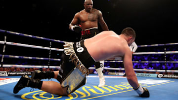Dillian Whyte (back) knocks down Joseph Parker during their prior to his WBC Silver Heavyweight title and WBO International Heavyweight title at the O2 Arena, London. (Photo by Nick Potts/PA Images via Getty Images)