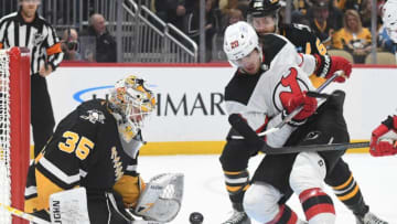 Nov 16, 2023; Pittsburgh, Pennsylvania, USA; Pittsburgh Penguins goalie Tristan Jarry (35) stops New Jersey Devils center Michael McLeod (20) during the second period at PPG Paints Arena. Mandatory Credit: Philip G. Pavely-USA TODAY Sports