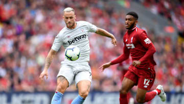 LIVERPOOL, ENGLAND - AUGUST 12: Marko Arnautovic of West Ham United controls the ball under pressure from Joe Gomez of Liverpool during the Premier League match between Liverpool FC and West Ham United at Anfield on August 12, 2018 in Liverpool, United Kingdom. (Photo by Laurence Griffiths/Getty Images)