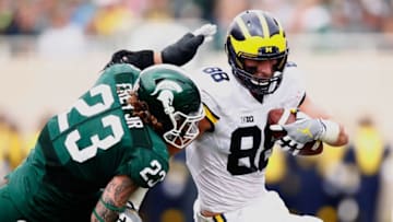 EAST LANSING, MI - OCTOBER 29: Jake Butt #88 of the Michigan Wolverines looks to get around the tackle of Chris Frey #23 of the Michigan State Spartans after a third quarter catch at Spartan Stadium on October 29, 2016 in East Lansing, Michigan. Michigan won the game 32-23. (Photo by Gregory Shamus/Getty Images)