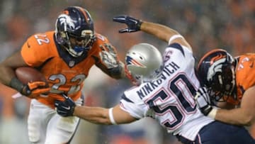 Nov 29, 2015; Denver, CO, USA; New England Patriots defensive end Rob Ninkovich (50) attempts to tackle Denver Broncos running back C.J. Anderson (22) as tackle Michael Schofield (79) run blocks in the first quarter at Sports Authority Field at Mile High. Mandatory Credit: Ron Chenoy-USA TODAY Sports